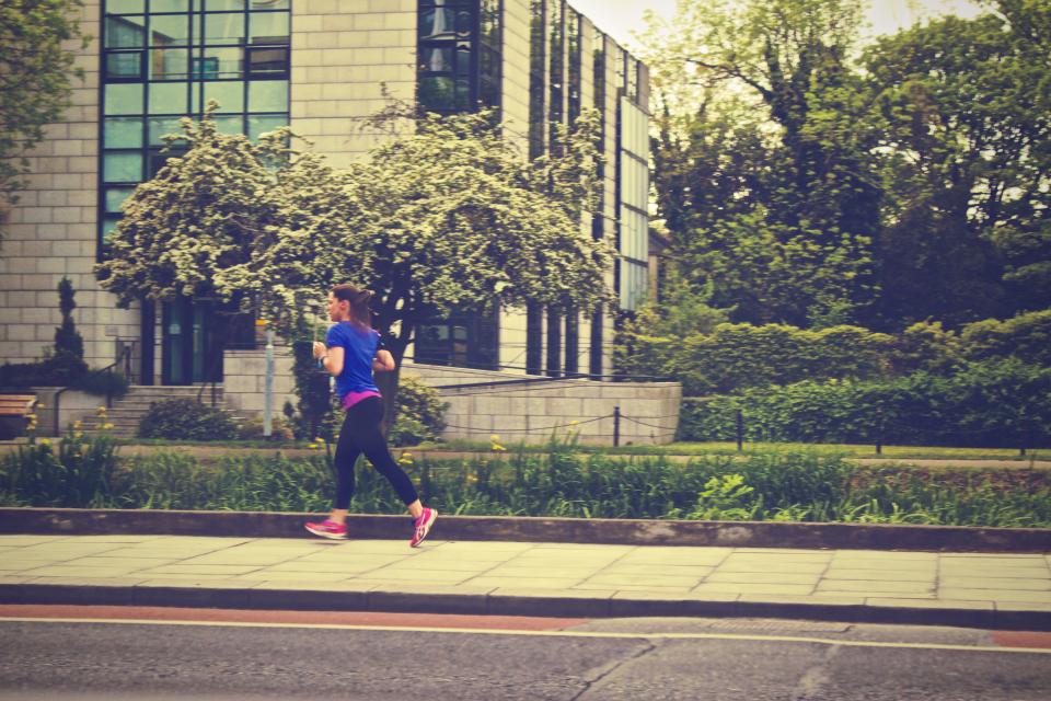 woman urban street sidewalk running runner jogging girl fitness exercise city building athlete 