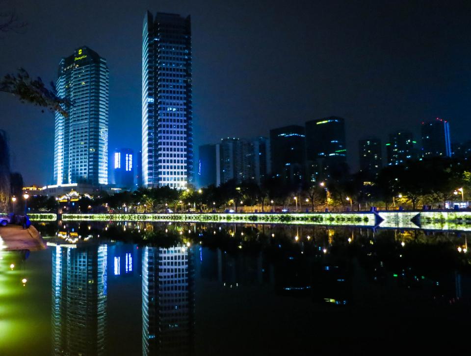 water towers skyline reflection night lights dark city china Chengdu buildings 