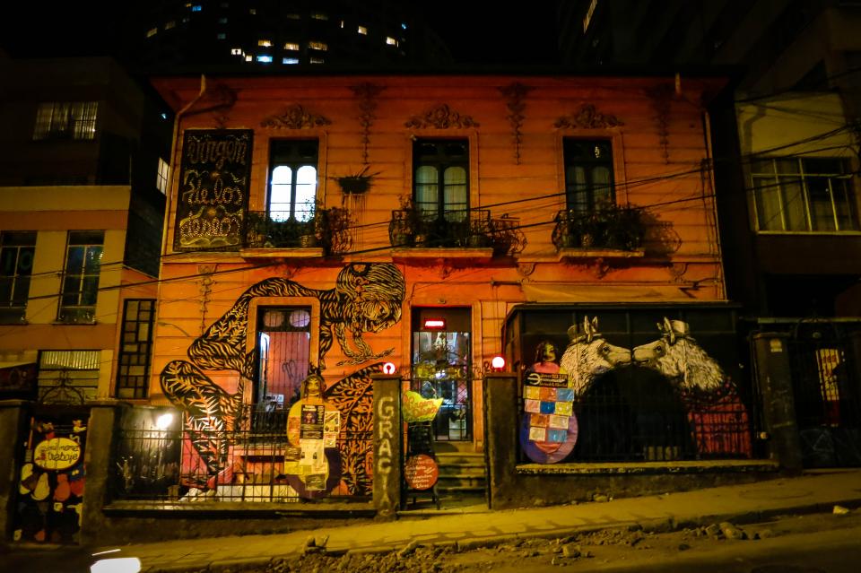 Windows spraypaint sidewalk railings night mural graffiti entrance dark BuildinginLaPaz building Bolivia art 