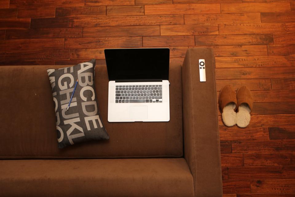 sofa slippers remote pillow pencil MacBook loft laptop hardwood floors couch condo apple apartment 
